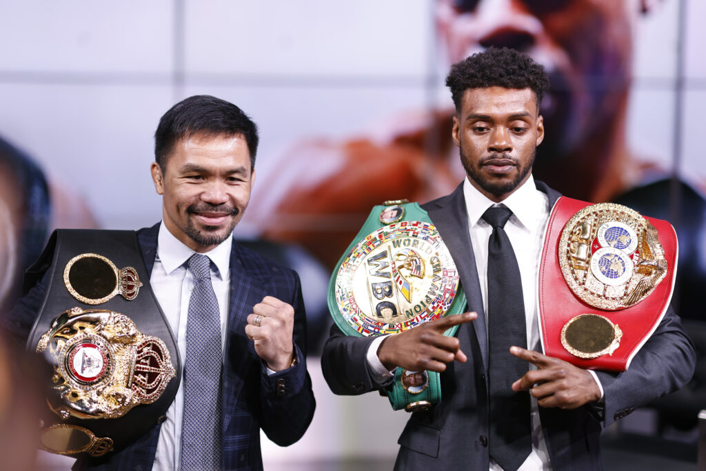 Manny Pacquiao and Errol Spence Jr. pose for photographs after their pre-fight press conference in 2021