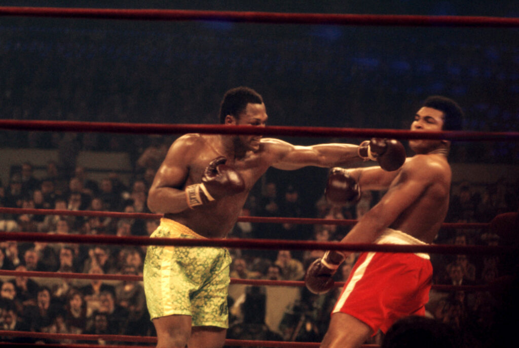 Joe Frazier punches Muhammad Ali in their 1971 Fight of the Century heavyweight bout
