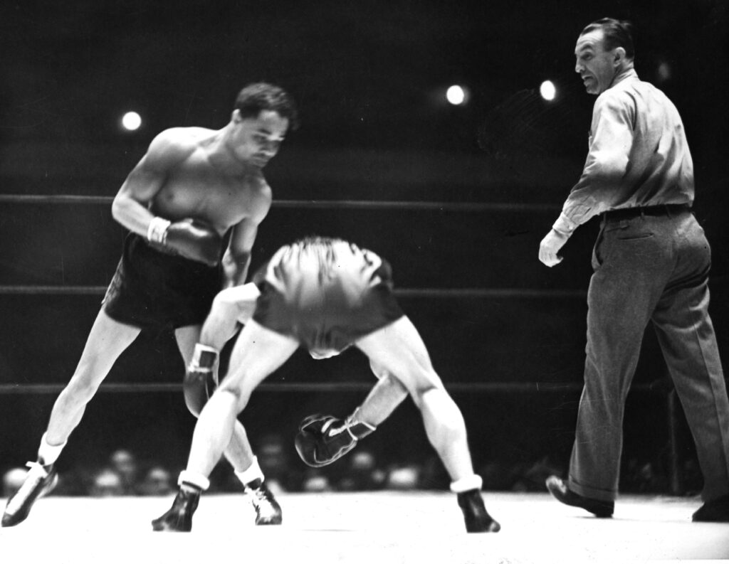 Henry Armstrong punches Petey Sarron during their featherweight title in 1937 fight in