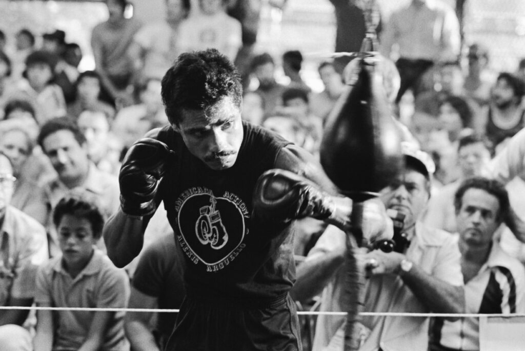 Alexis Arguello training on a speed bag as fans watch on in the gym before his 1982 fight in Miami